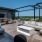 Rooftop lounge area with couches and a tv