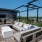 Rooftop lounge area with couches and a tv